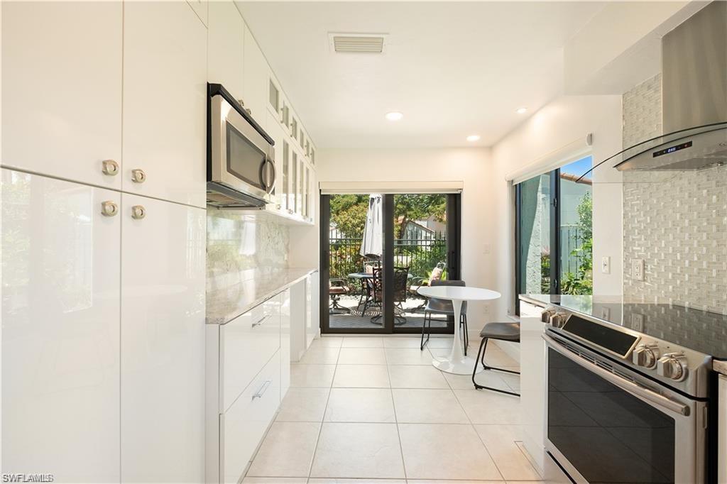 845 Reef Point Circle Naples, FL 34108 - Photo 7 of 41 a lobby with furniture and floor to ceiling windows