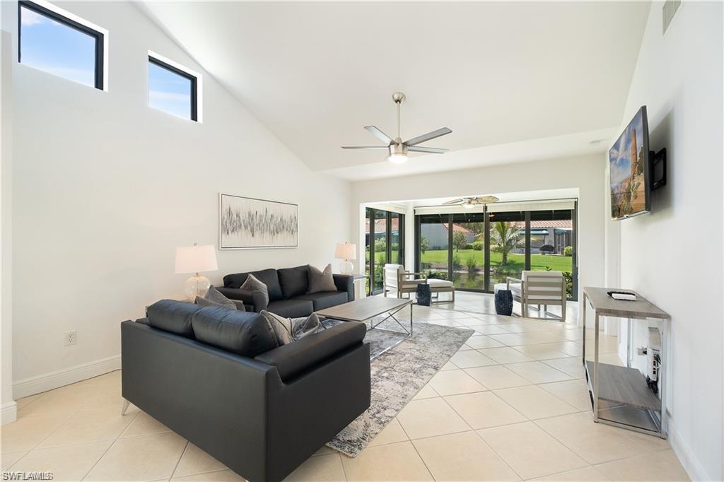 845 Reef Point Circle Naples, FL 34108 - Photo 9 of 41 a living room with furniture and large windows
