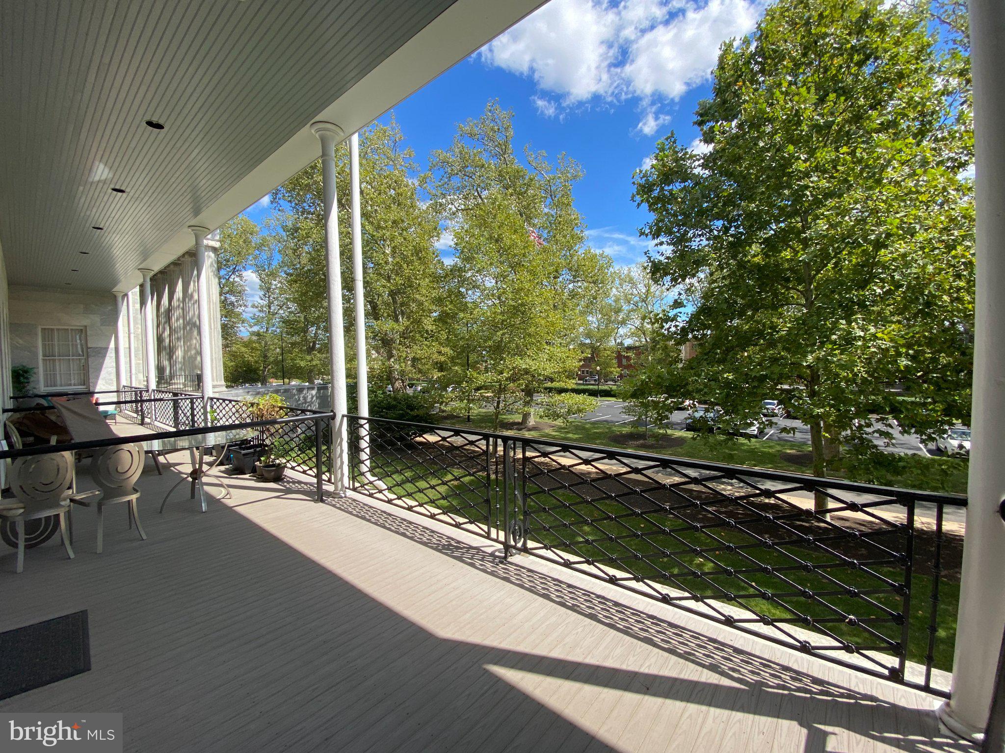 1 Academy Circle, Unit 204 Philadelphia, PA 19146 - Photo 14 of 26 Serene balcony with lush greenery.