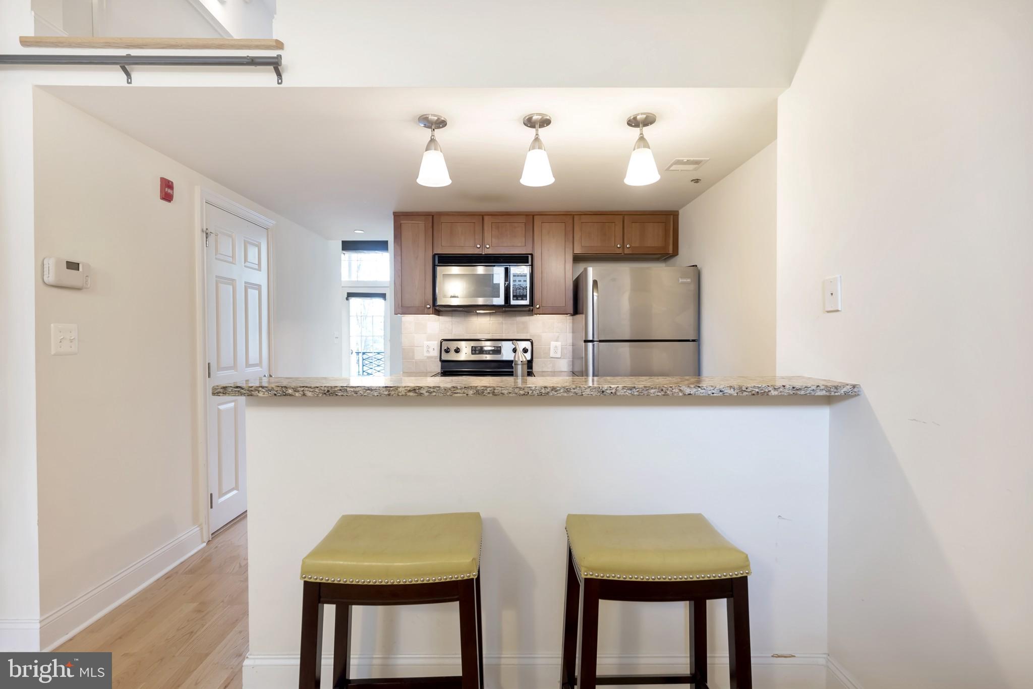 1 Academy Circle, Unit 204 Philadelphia, PA 19146 - Photo 3 of 26 Modern kitchen with inviting bar area.