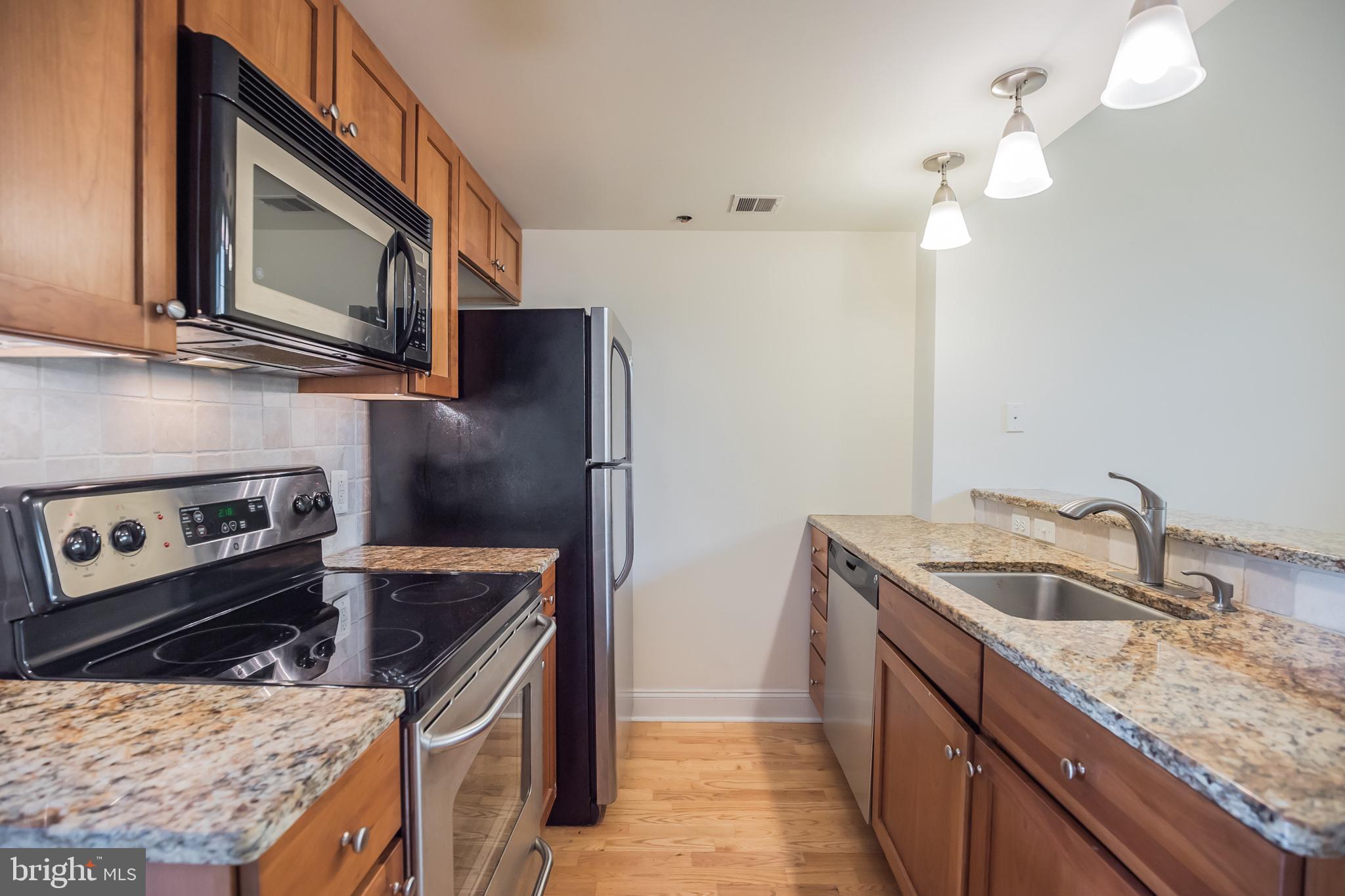 1 Academy Circle, Unit 204 Philadelphia, PA 19146 - Photo 8 of 26 Modern kitchen with sleek finishes.