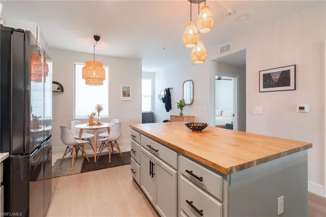 a view of a kitchen center island and living room