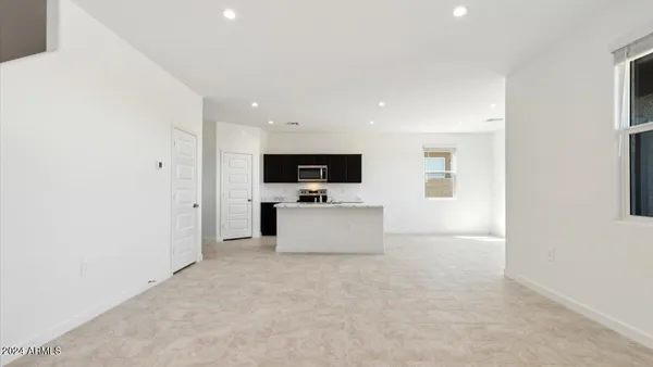 a view of kitchen with microwave oven stove and cabinets