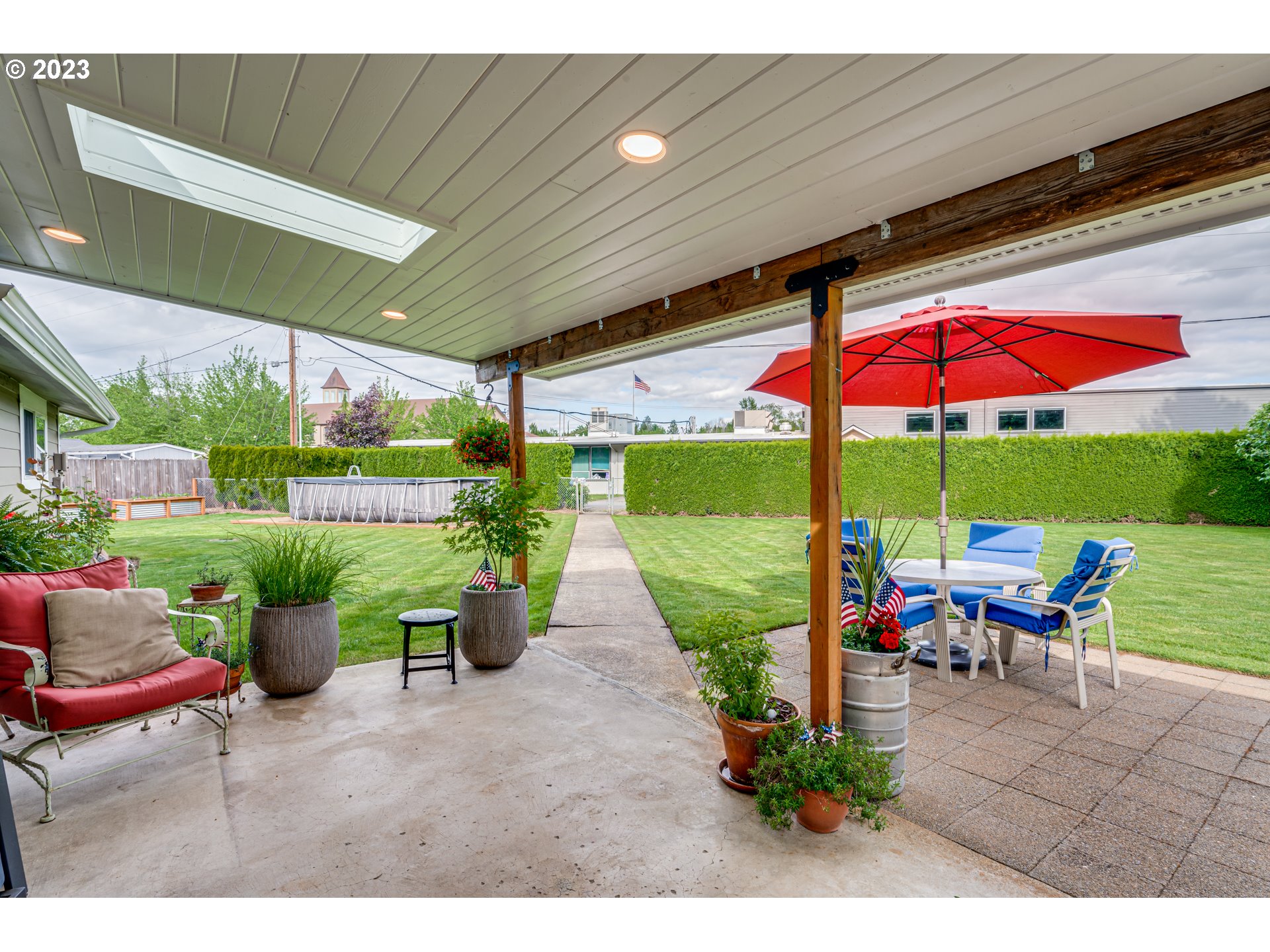 18721 Northeast Cramer Road Battle Ground, WA 98604 - Photo 28 of 32 a view of a patio with a table and chairs under an umbrella