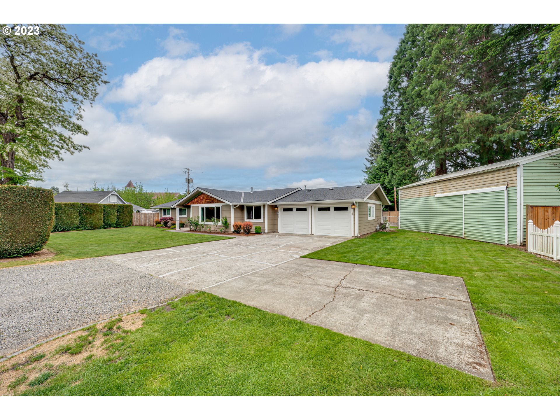 18721 Northeast Cramer Road Battle Ground, WA 98604 - Photo 3 of 32 a front view of a house with a yard and garage