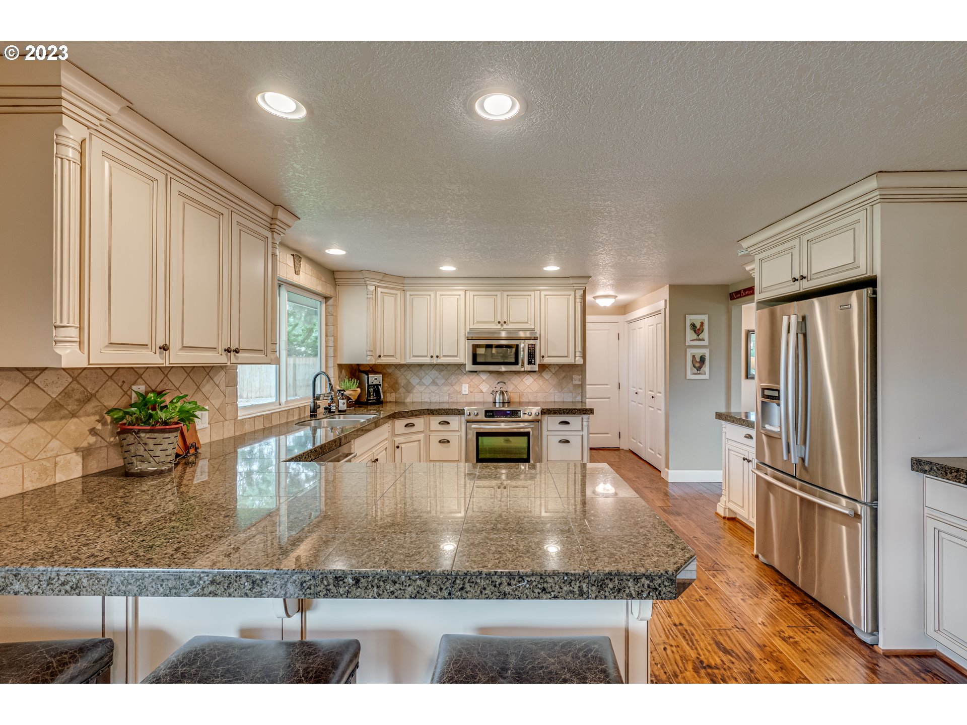 18721 Northeast Cramer Road Battle Ground, WA 98604 - Photo 5 of 32 a kitchen with sink refrigerator and cabinets