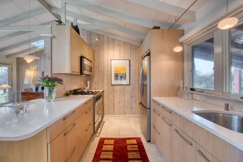 a spacious bathroom with a double vanity sink a mirror and a shower