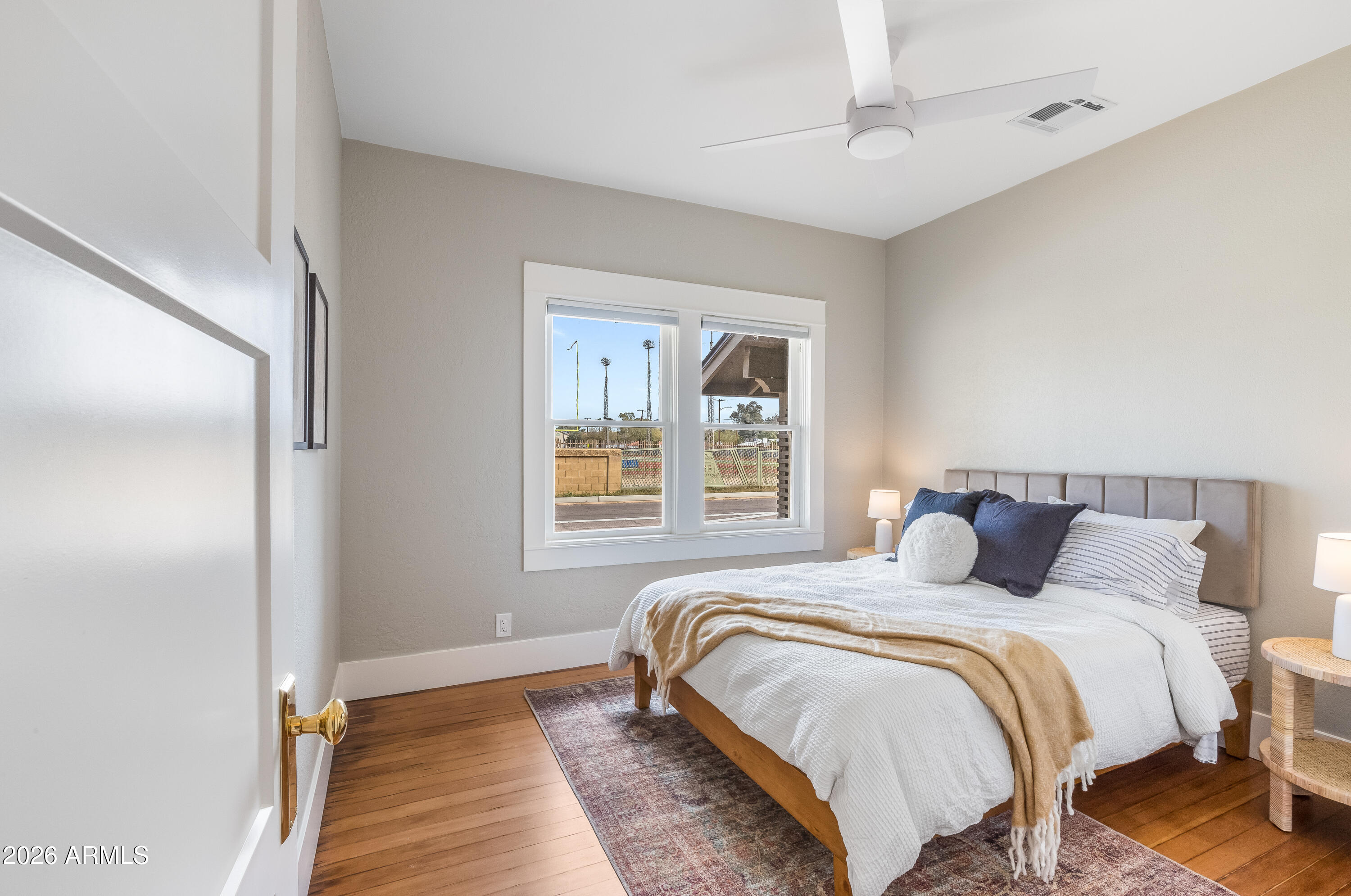 2549 North Mitchell Street Phoenix, AZ 85006 - Photo 22 of 41 a bedroom with a bed and wooden floor