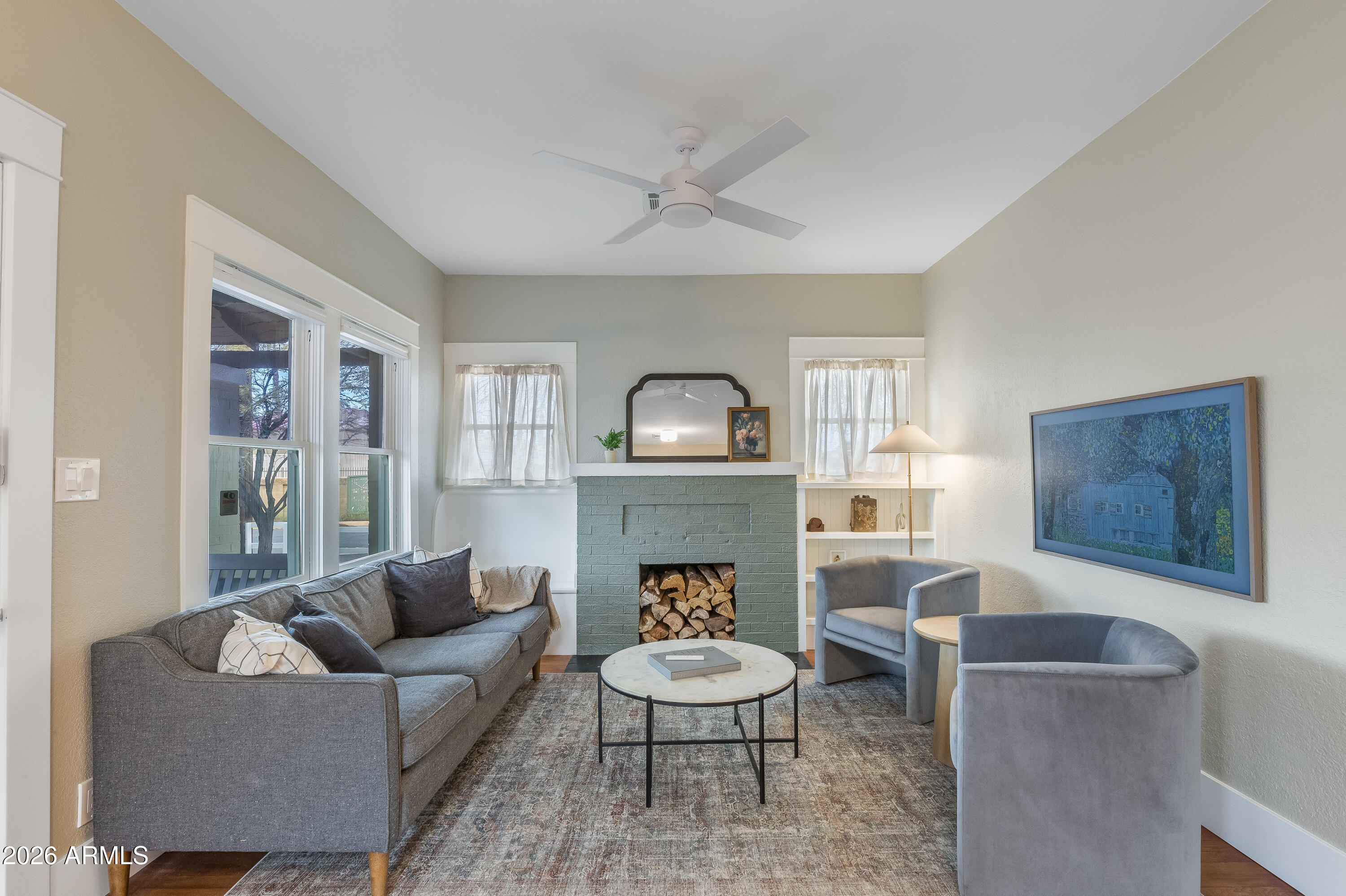 2549 North Mitchell Street Phoenix, AZ 85006 - Photo 4 of 41 a living room with furniture a fireplace and a large mirror next to a window