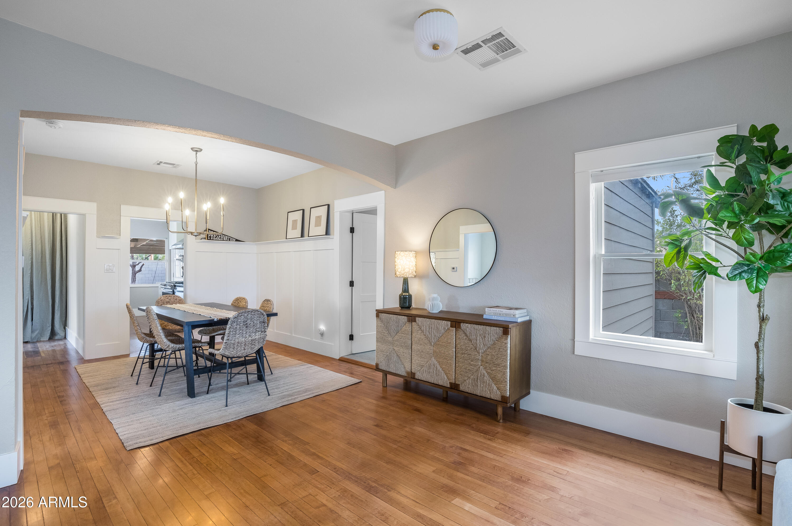 2549 North Mitchell Street Phoenix, AZ 85006 - Photo 8 of 41 a living room with furniture a dining table wooden floor and a large window