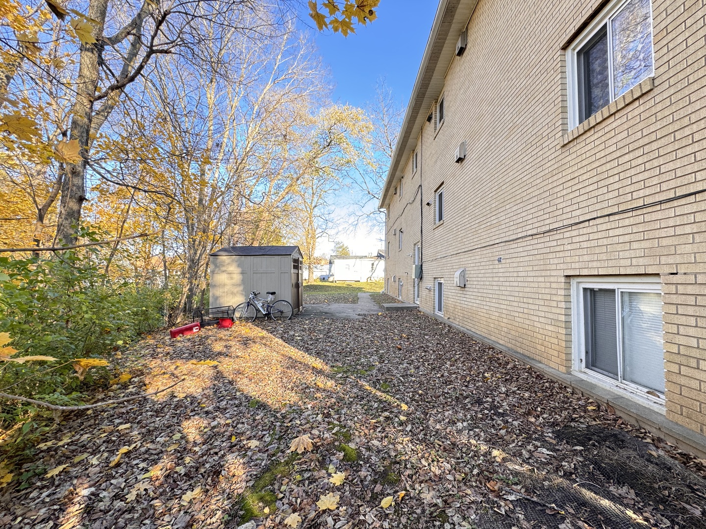 901 Walnut Avenue Dixon, IL 61021 - Photo 2 of 15 a backyard of a house with wooden fence and large trees
