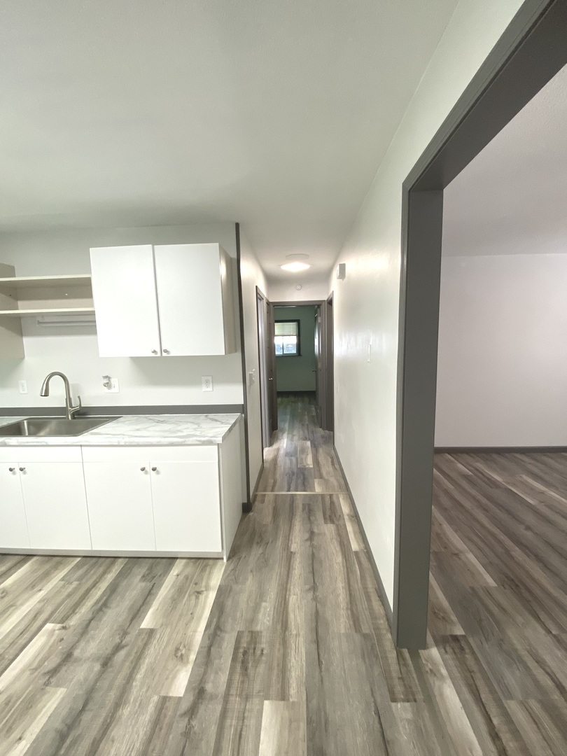 901 Walnut Avenue Dixon, IL 61021 - Photo 10 of 15 a view of a kitchen with wooden floor and a sink