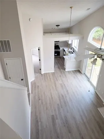 a view of a living room a hardwood and a ceiling fan