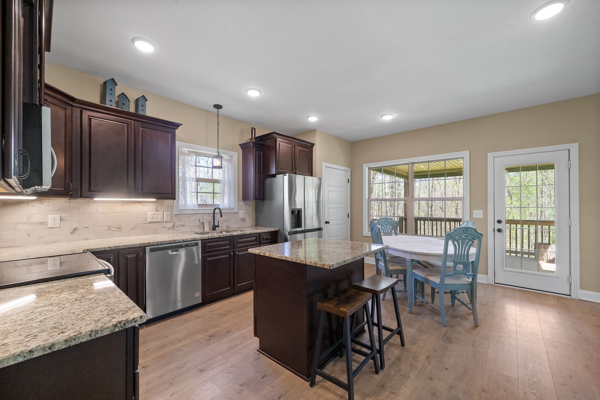 4406 Memory Lane Adams, TN 37010 - Photo 12 of 36 a kitchen with granite countertop sink stove and dining table