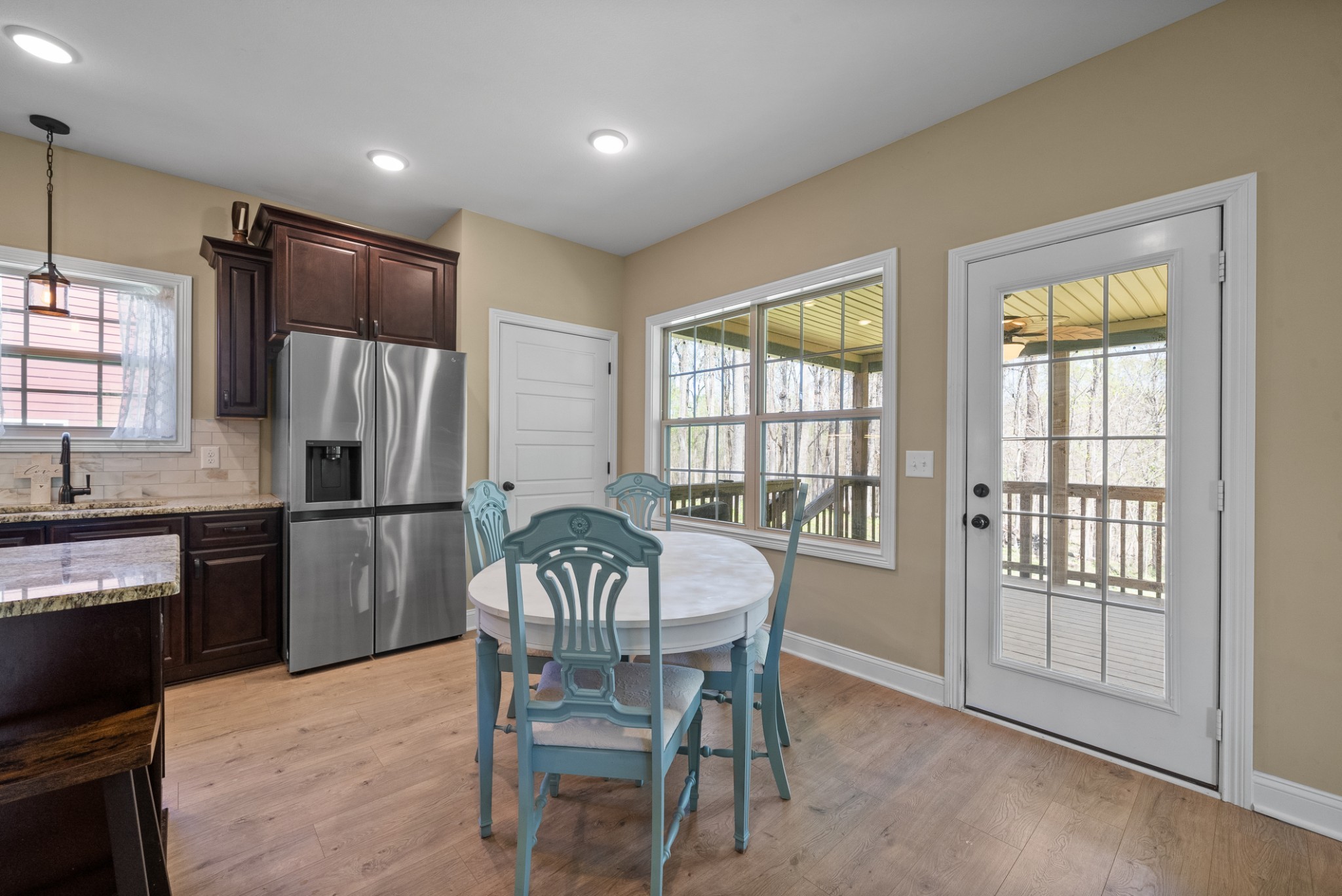 4406 Memory Lane Adams, TN 37010 - Photo 15 of 36 a kitchen with a table chairs refrigerator and microwave