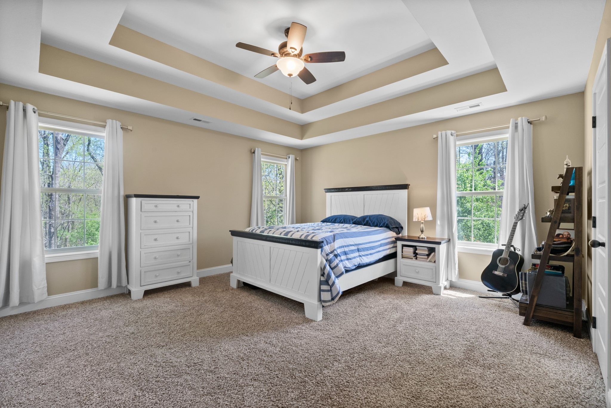 4406 Memory Lane Adams, TN 37010 - Photo 18 of 36 a spacious bedroom with a bed a ceiling fan and a large window