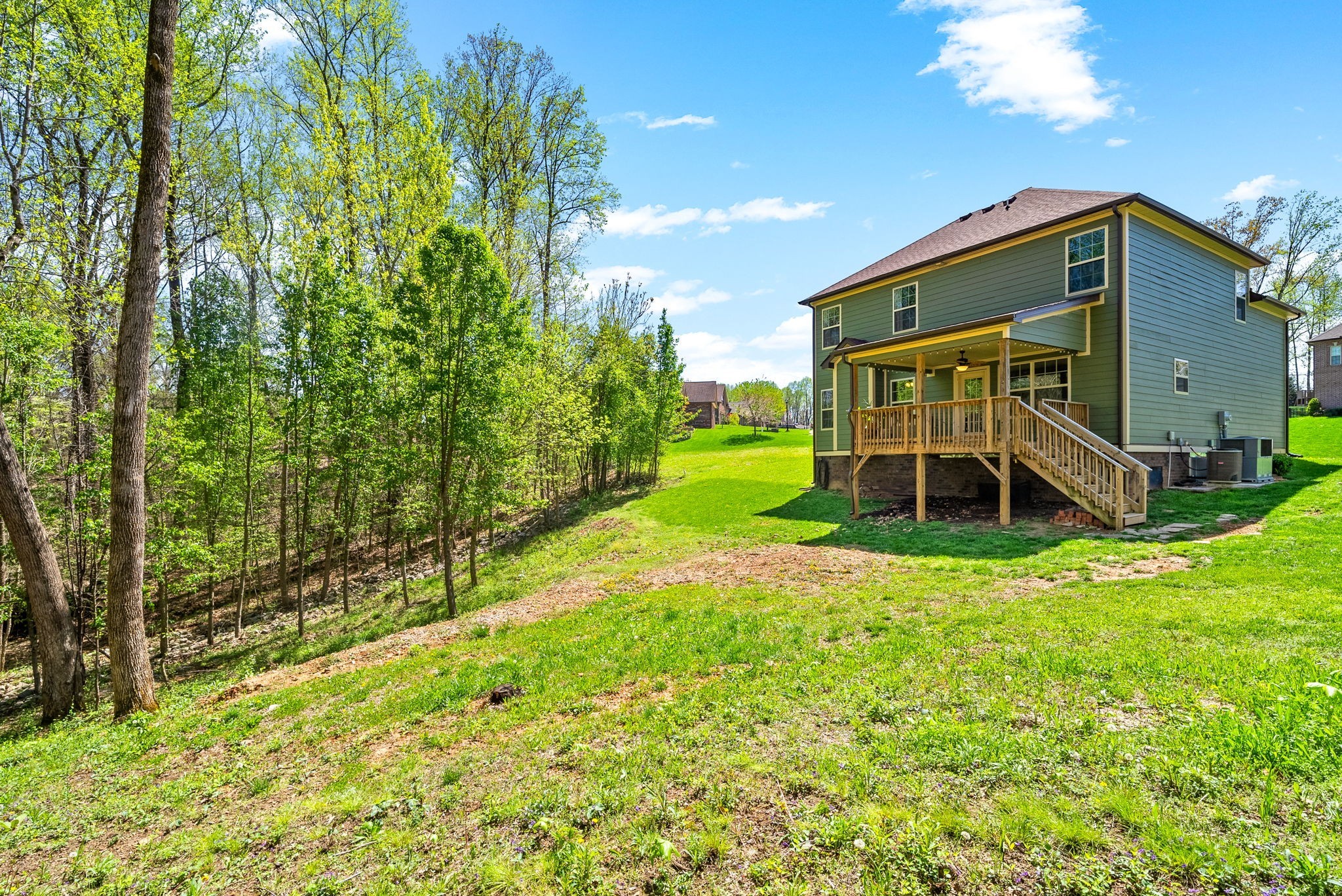 4406 Memory Lane Adams, TN 37010 - Photo 30 of 36 a view of a wooden house with a big yard and large trees