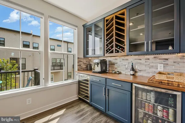 a living room with furniture a rug and wooden floor
