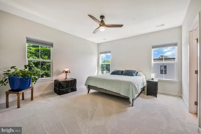 a bedroom with a bed and a potted plant