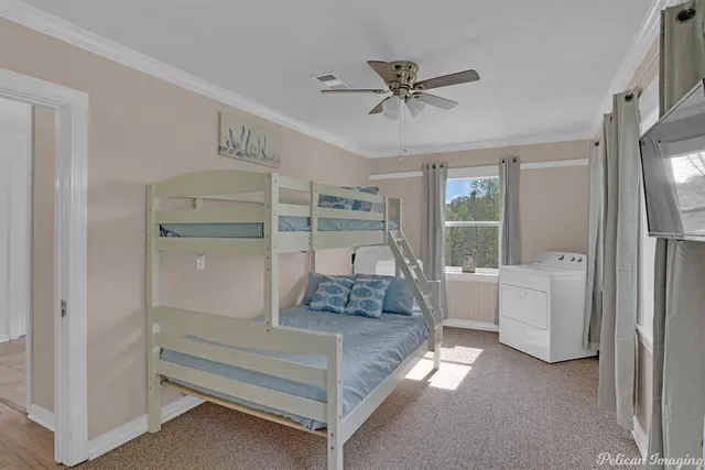 a bedroom with a bed and a large window