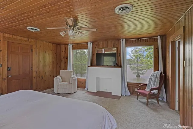 a bedroom with a bed and large window