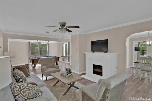a living room with furniture a fireplace and a flat screen tv