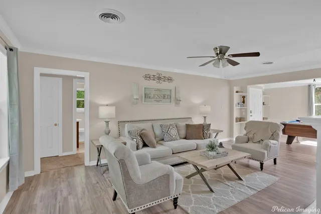 a living room with furniture and a wooden floor
