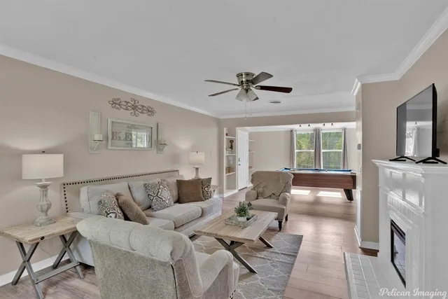 a living room with furniture a flat screen tv and a fireplace