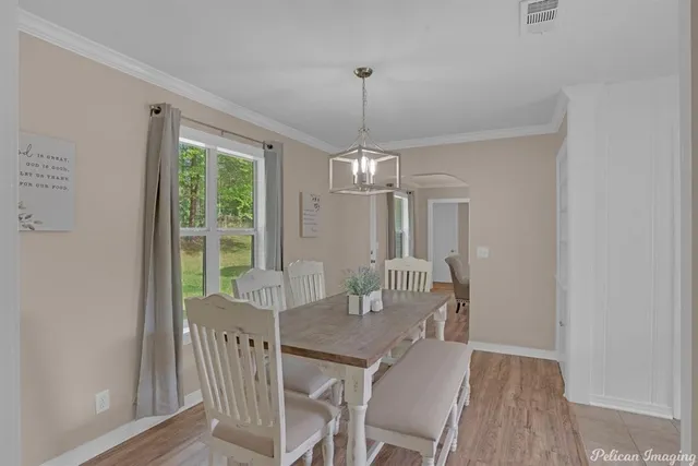 a view of a dining room with furniture window and outside view