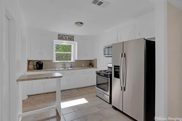 a kitchen with a refrigerator and a sink