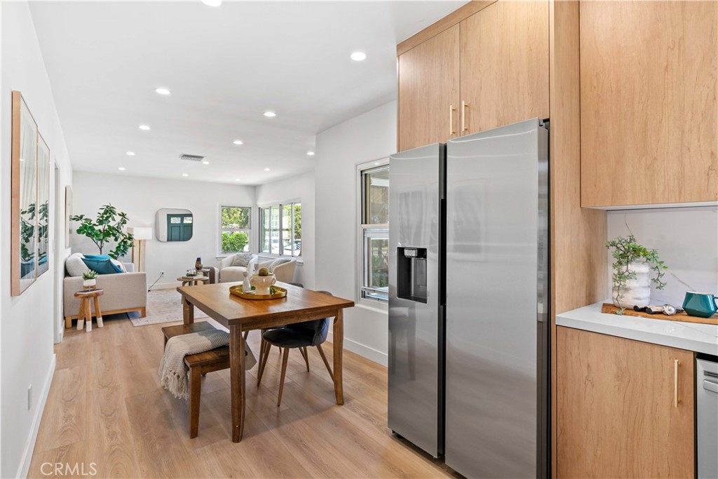 2105 N Pass Burbank, CA 91505 - Photo 15 of 31 a kitchen with stainless steel appliances refrigerator dining table and chairs
