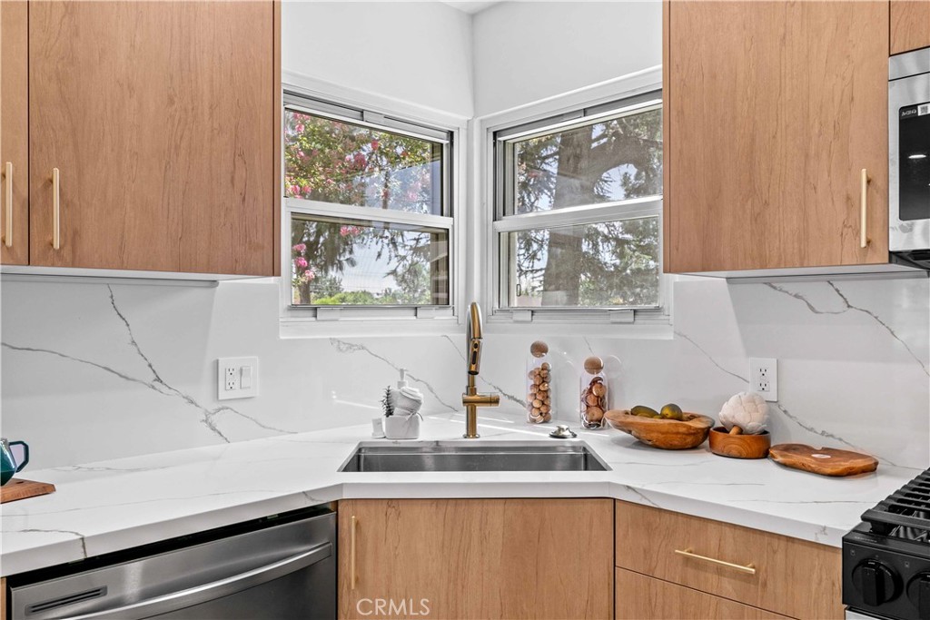 2105 N Pass Burbank, CA 91505 - Photo 17 of 31 a kitchen with stainless steel appliances a sink a stove and a window
