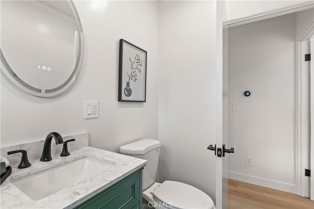 2105 N Pass Burbank, CA 91505 - Photo 26 of 31 a bathroom with a granite countertop toilet sink and mirror