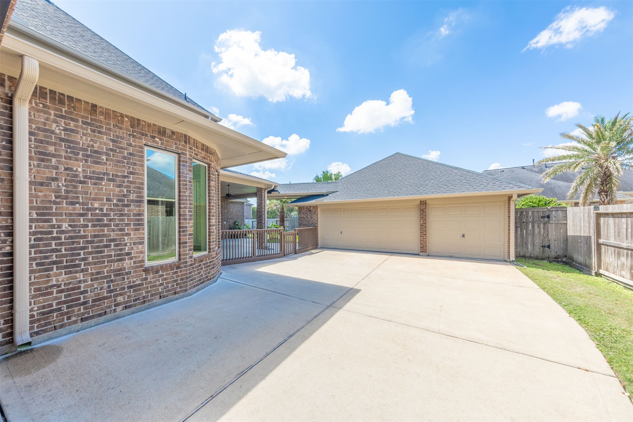 5803 Mustang Ridge Lane Fulshear, TX 77441 - Photo 42 of 48 Oversized driveway lead to the detached 3 car garage, creating a private courtyard-style entrance with ample parking. Covered access between the home and garage adds both convenience and architectural charm.