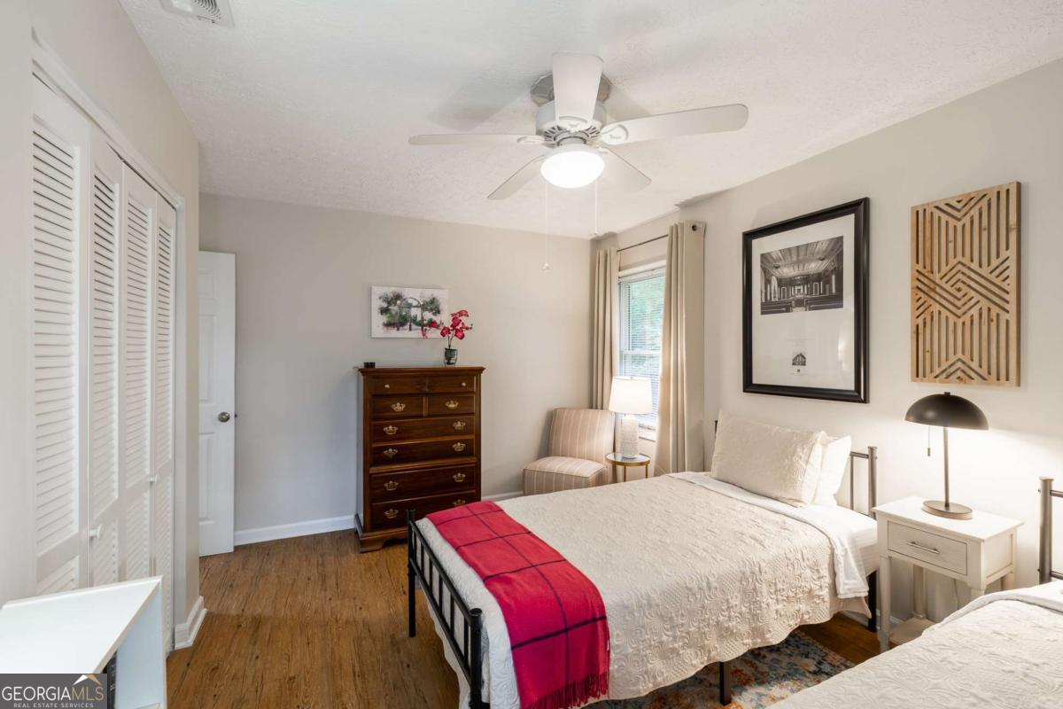 168 Pearl Street Athens, GA 30601 - Photo 22 of 43 a bedroom with a bed and a chandelier