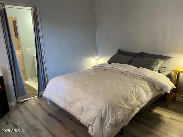 a large bed sitting in a bedroom next to a window