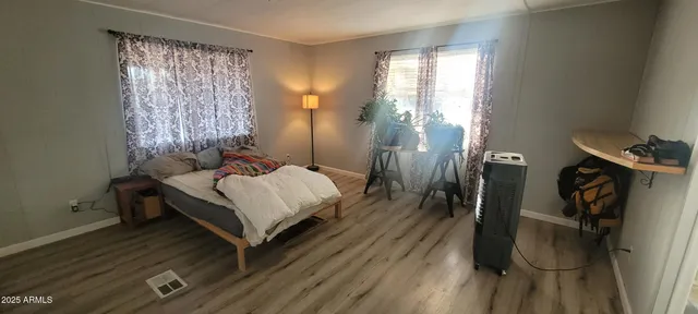 a bed sitting in a bedroom next to a window