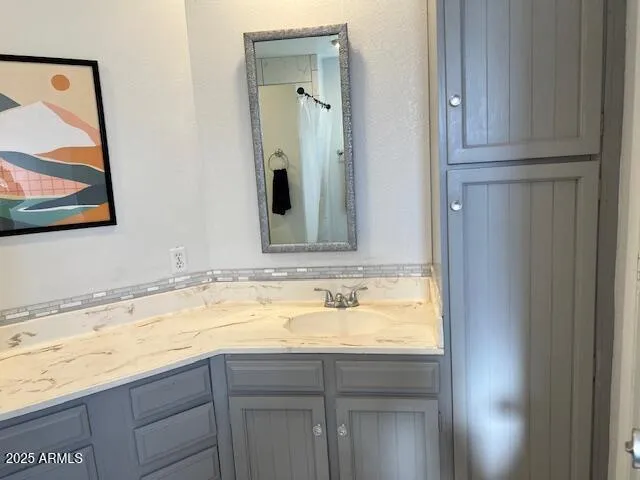 a bathroom with a sink and vanity