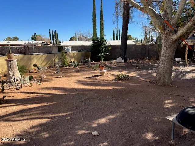 a backyard of a house with fountain table and chairs