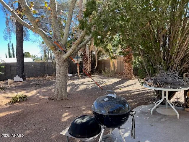 a view of a patio with table and chairs and potted plants
