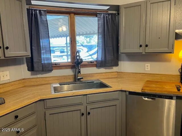a kitchen with stainless steel appliances granite countertop a sink and a window