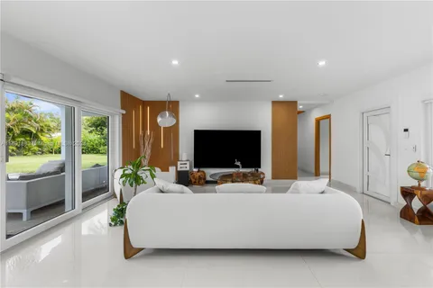 a bedroom with a bed and large windows