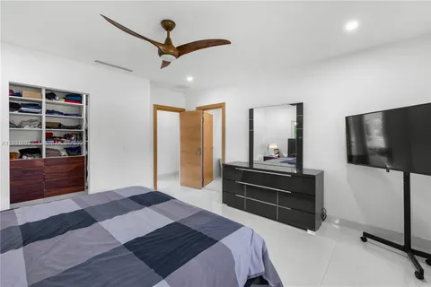 a bedroom with a bed dresser and a window