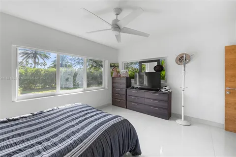 a view of pool with chairs and tables