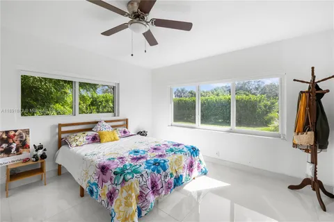 a view of a patio with a table chairs and a backyard