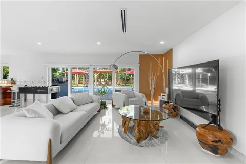 a kitchen with kitchen island a stove and a sink