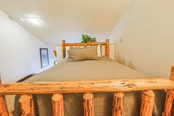 a bedroom with a bed and a table