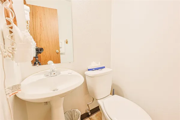 a white toilet sitting next to a white sink