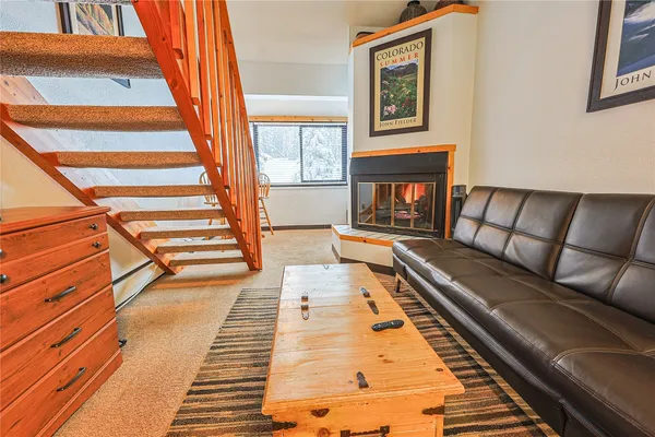 a living room with a couch and a fireplace