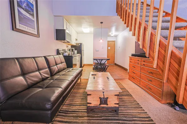 a large living room with stainless steel appliances